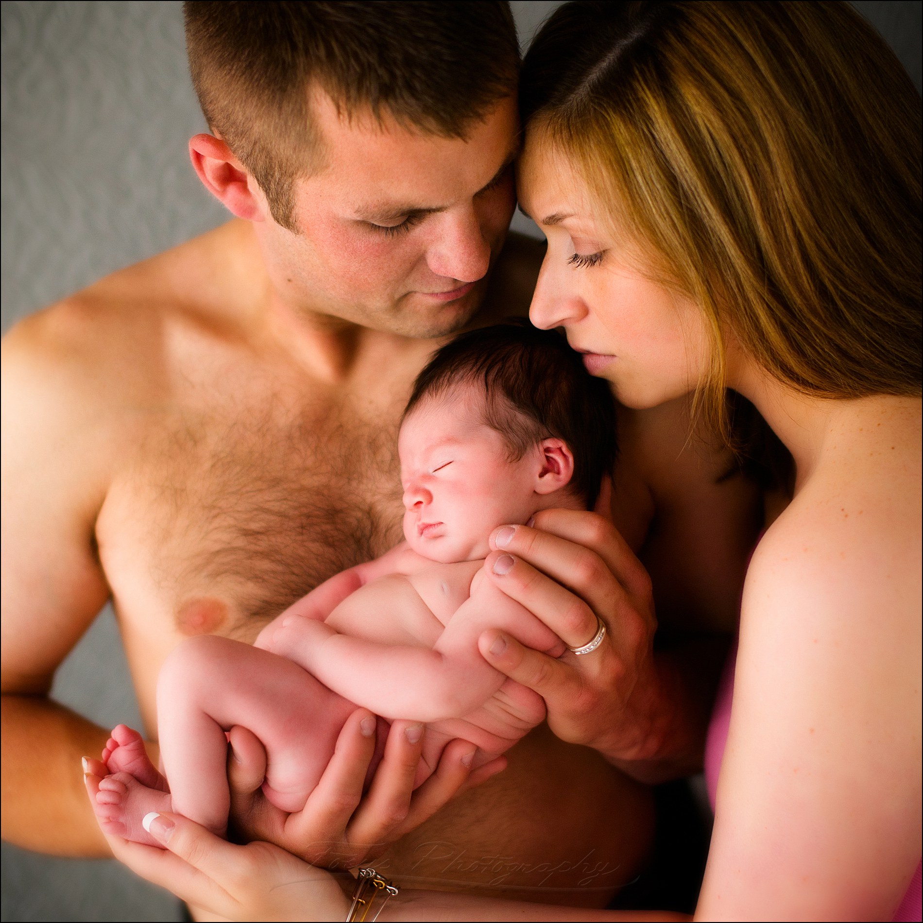 newborn family photography in studio of parents and baby