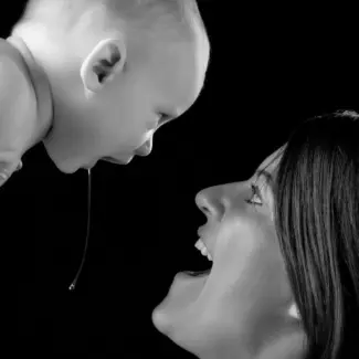 newborn baby drooling on mom in black and white