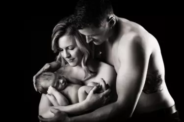 parents hold baby in black and white portrait in photography studio in maine family picture.