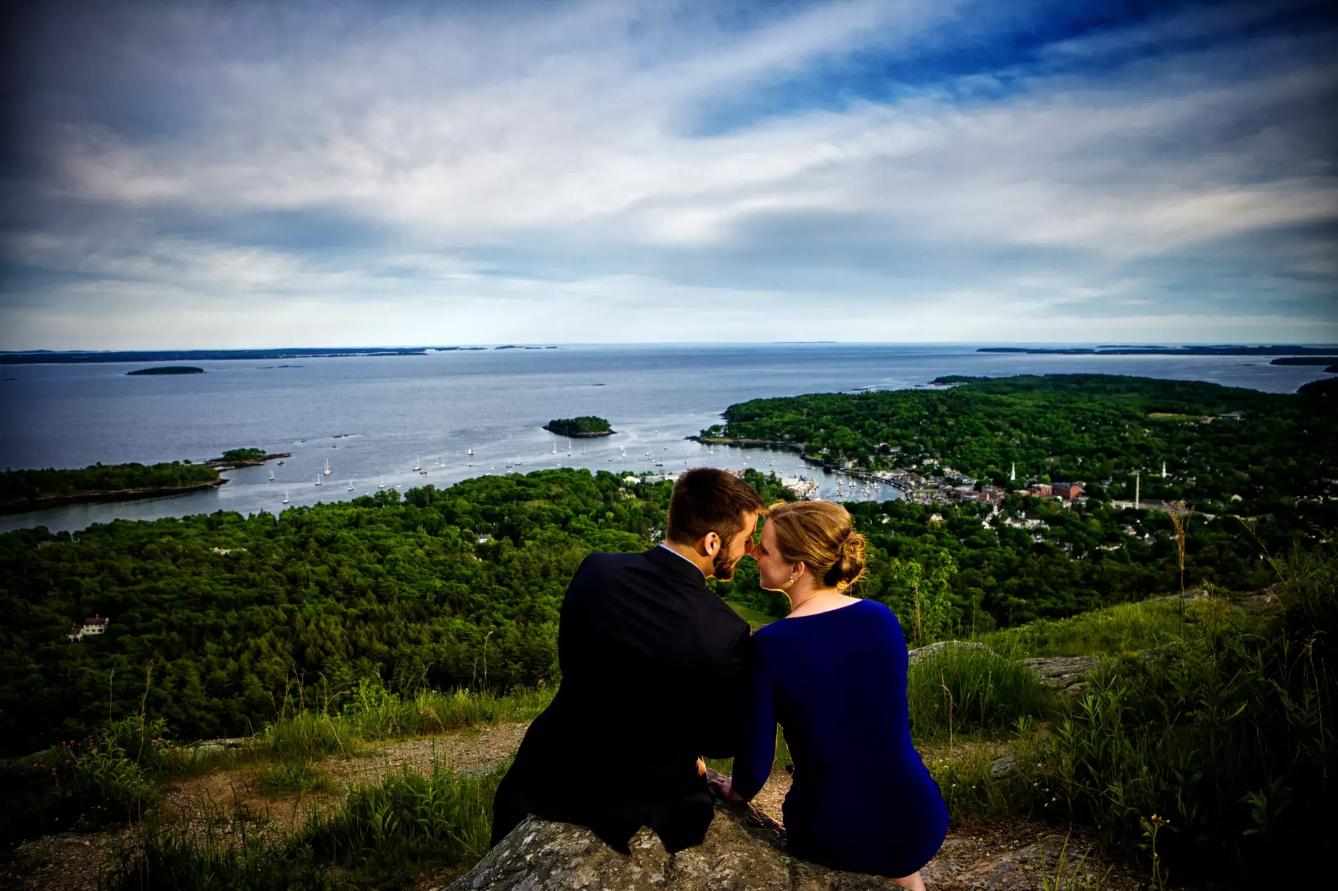 engaged couple overlooking the coast of maine at romantic photoshoot