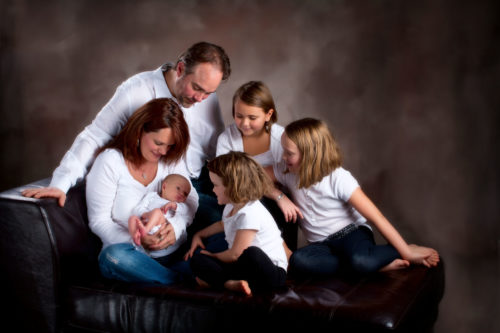 family portrait with new baby in photographers studio