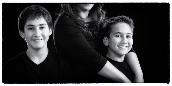 mom and her boys in black and white