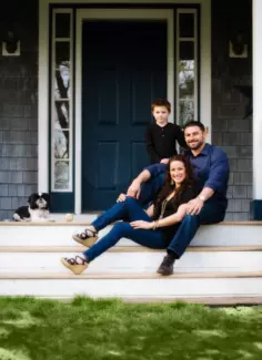 family on steps of their house in maine
