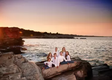 family portrait on the rocks of the maine coast by professional photographer Focus Photography