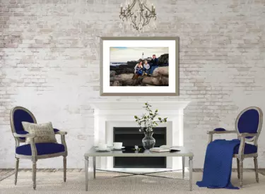 framed portrait of maine family hanging over the mantlepiece of the fireplace