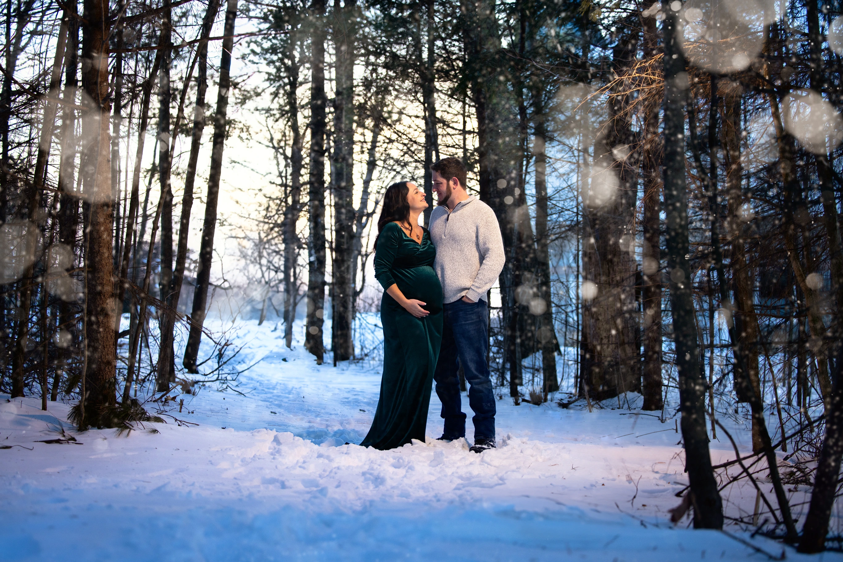 maternity pictures taken outside in maine at snowy woods and field