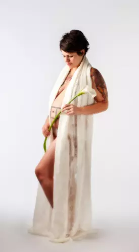 Pregnant woman in lace gown holding flower at Focus Photography studio in Maine maternity photoshoot professional maternity photographers pregnancy pictures