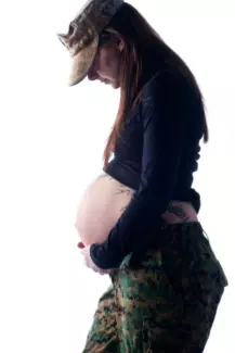 expecting mother in fatigues after army service