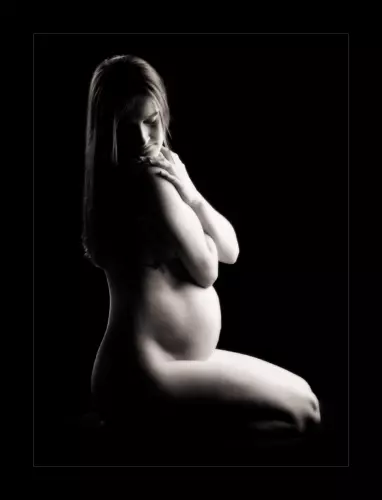 black and white portrait of pregnant mother in photography studio in maine