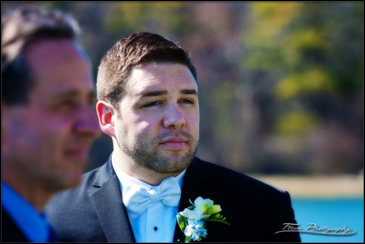 Groom looks at bride as she walks down the aisle