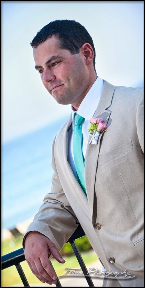 JT (the groom) leans on the railing at the Union Bluff Meeting House in York Beach, Maine - wedding photography by Focus