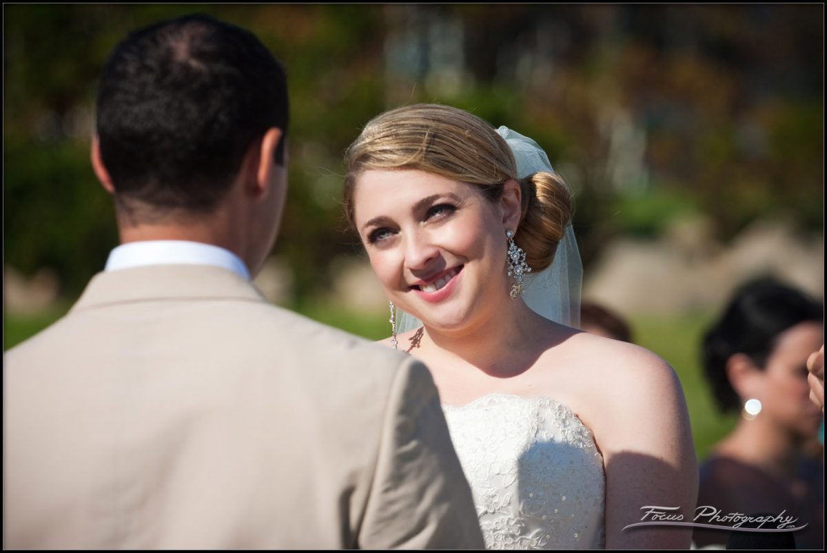 Bride smiles at groom at York wedding. Photography by Focus