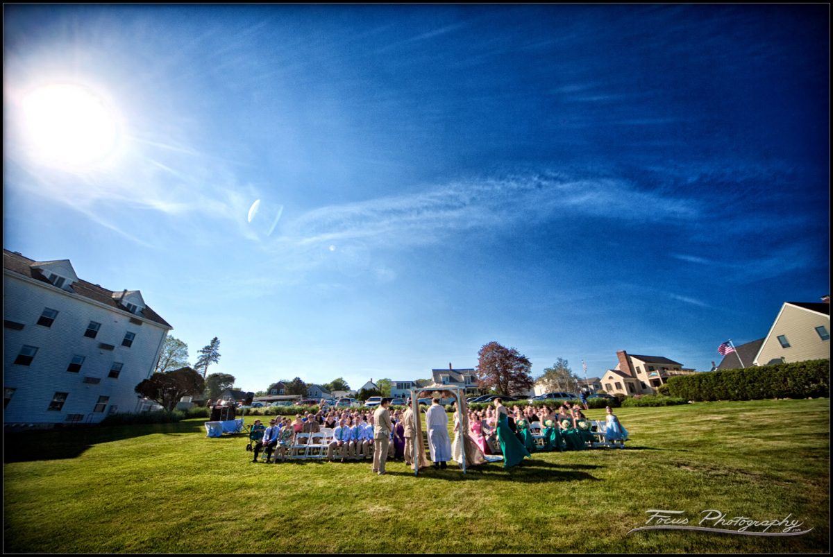 the view from the beach of the ceremony at the Union Bluff Meetng House in York, Maine