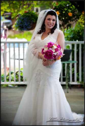 Full length shot of the bride and her wedding dress on the front porch of the Nonantum resort
