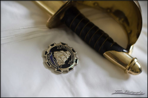 A Chief's coin and the cutlass of the Navy - shined and polished