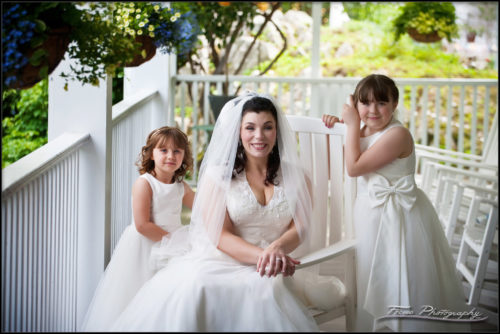 The bride and her daughters on the front porch of the Nonantum in Maine Wedding photography by Focus