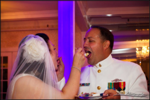 The bride and groom feed each other wedding cake