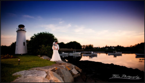 As the sun dips below the horizon, the bride and groom enjoy twilight. At the Nonantum resort in Kennebunkport, Maine. Wedding photography by Focus
