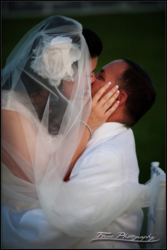 bride and groom kiss under the veil - Maine wedding photography by Focus