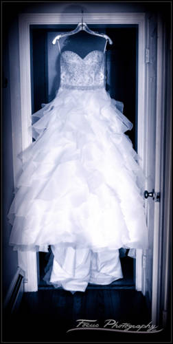 Bride's gown hanging in the doorway