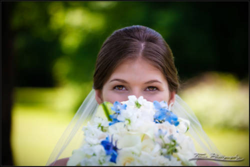 Kaitlin's eyes above her wedding bouquet