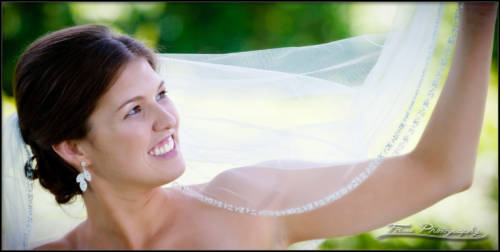 Bride holds up her wedding veil