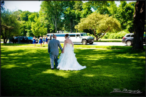 bride and groom walk to the limos to head to the wedding chapel