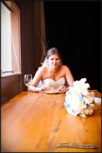 The bride and a slice of pizza before her wedding ceremony