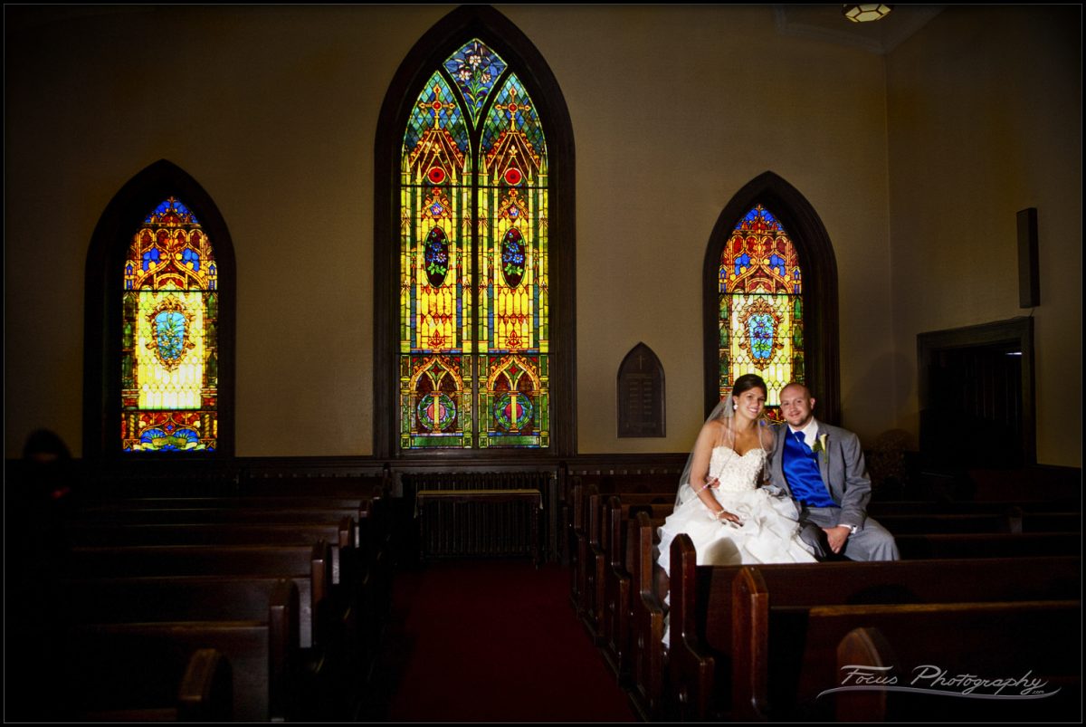 Bride and groom in church pews before the ceremony