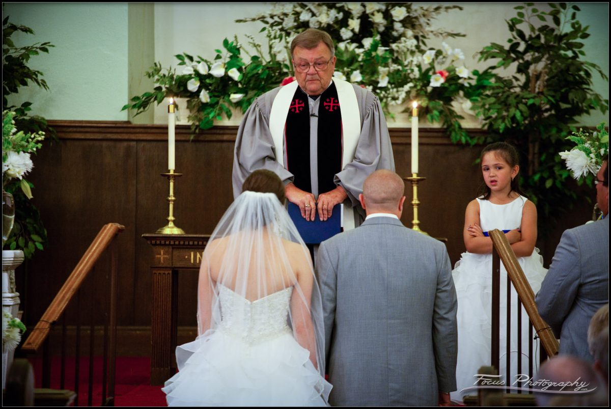 Bride and groom with daughter and minister