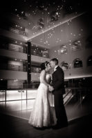 bride and groom kiss in atrium of the boston long wharf