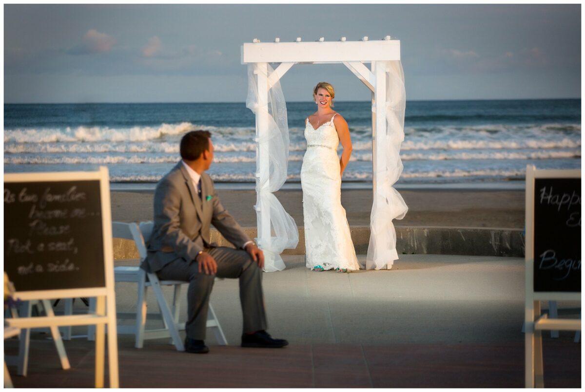 groom looking at bride on beach in newport wedding