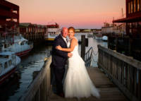 Bride and groom at sunset with Casco Bay in background.