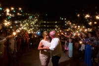 Bride and groom surrounded by guests with sparklers for a fiery exit from their wedding!