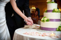 This is actually my all-time favorite cake-cutting picture.  We often frame the bride and groom this way - faces out of the shot, but hands on the knife together.  You see the action, you know the story, without looking the couple in the face.  But in this
