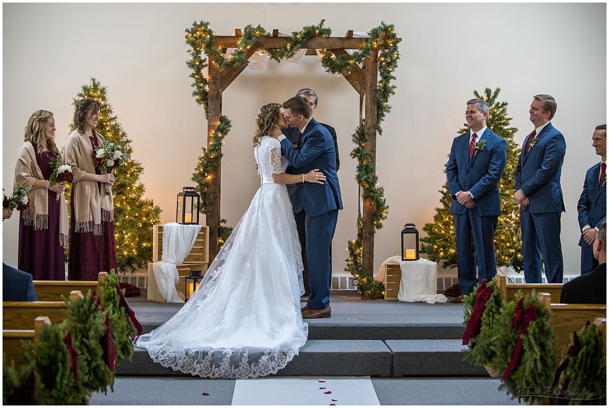 bride and groom kiss at baptist church wedding