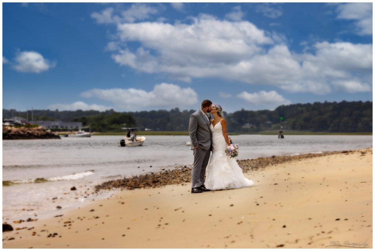 bride and groom kissing on beach on Drake's island