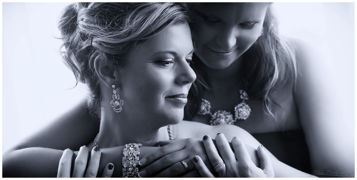 wedding photo of two brides showing their rings
