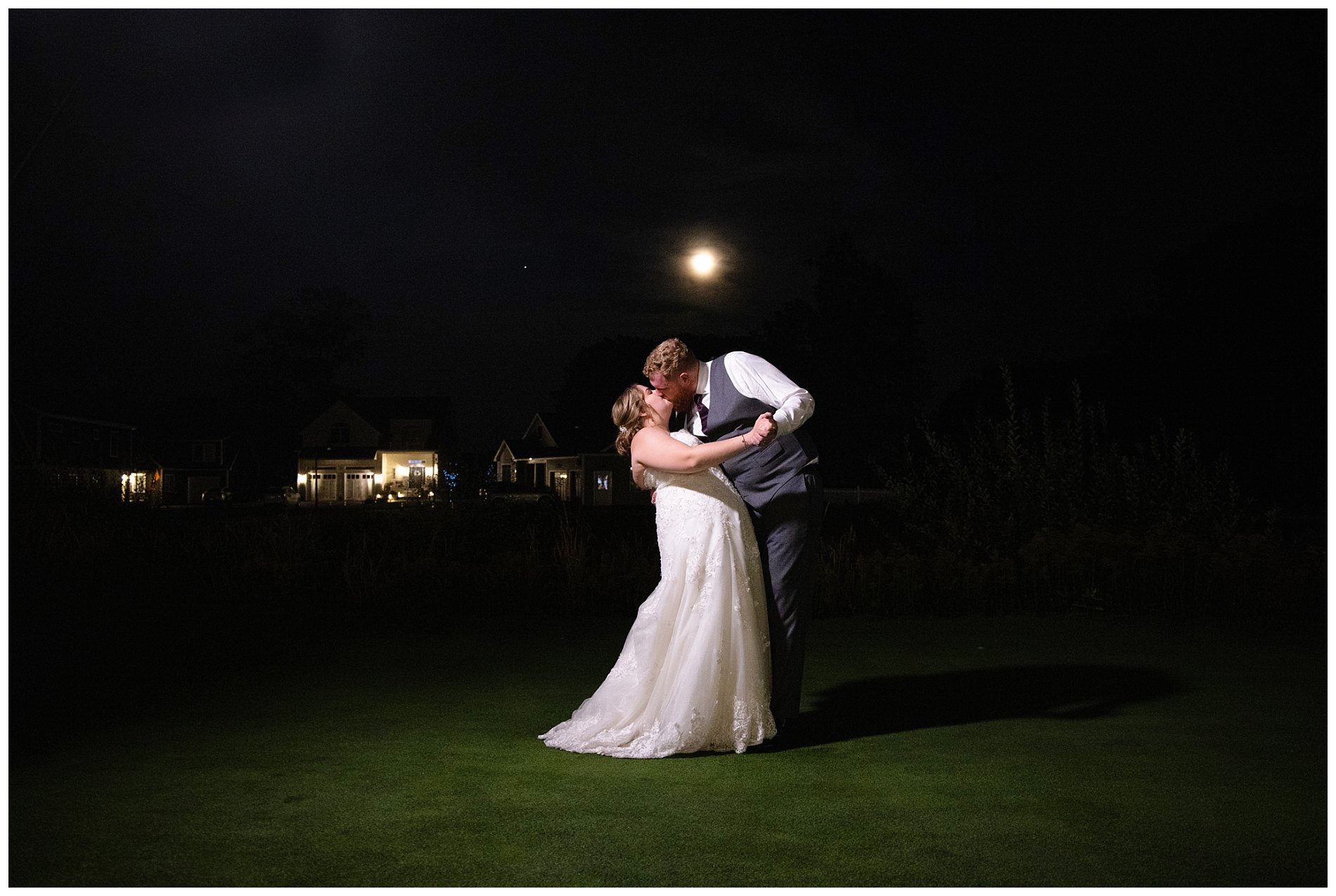 late night photo of wedding couple under the full fall moon