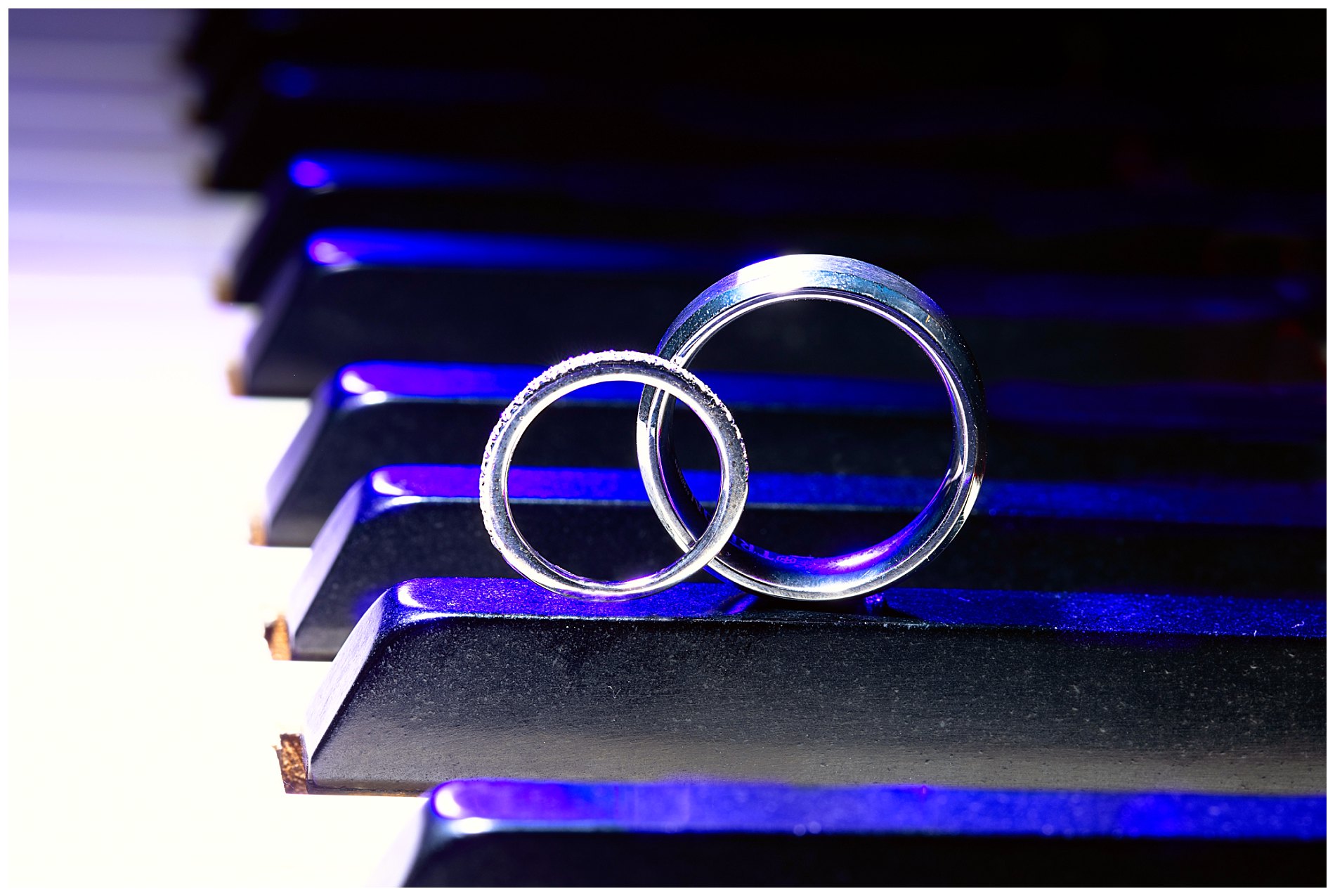 wedding rings on piano keyboard