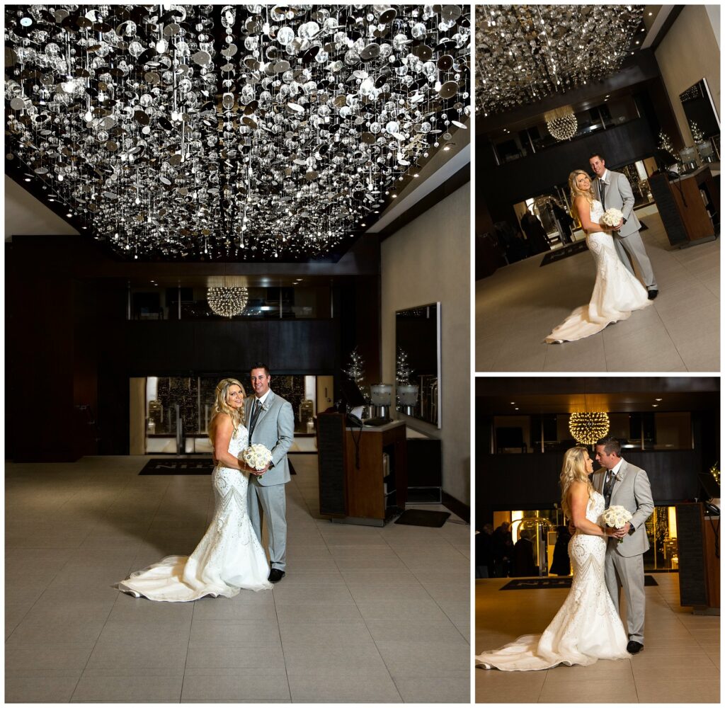 Main lobby of Westin hotel in portland, maine, with wedding couple under reflective disks.