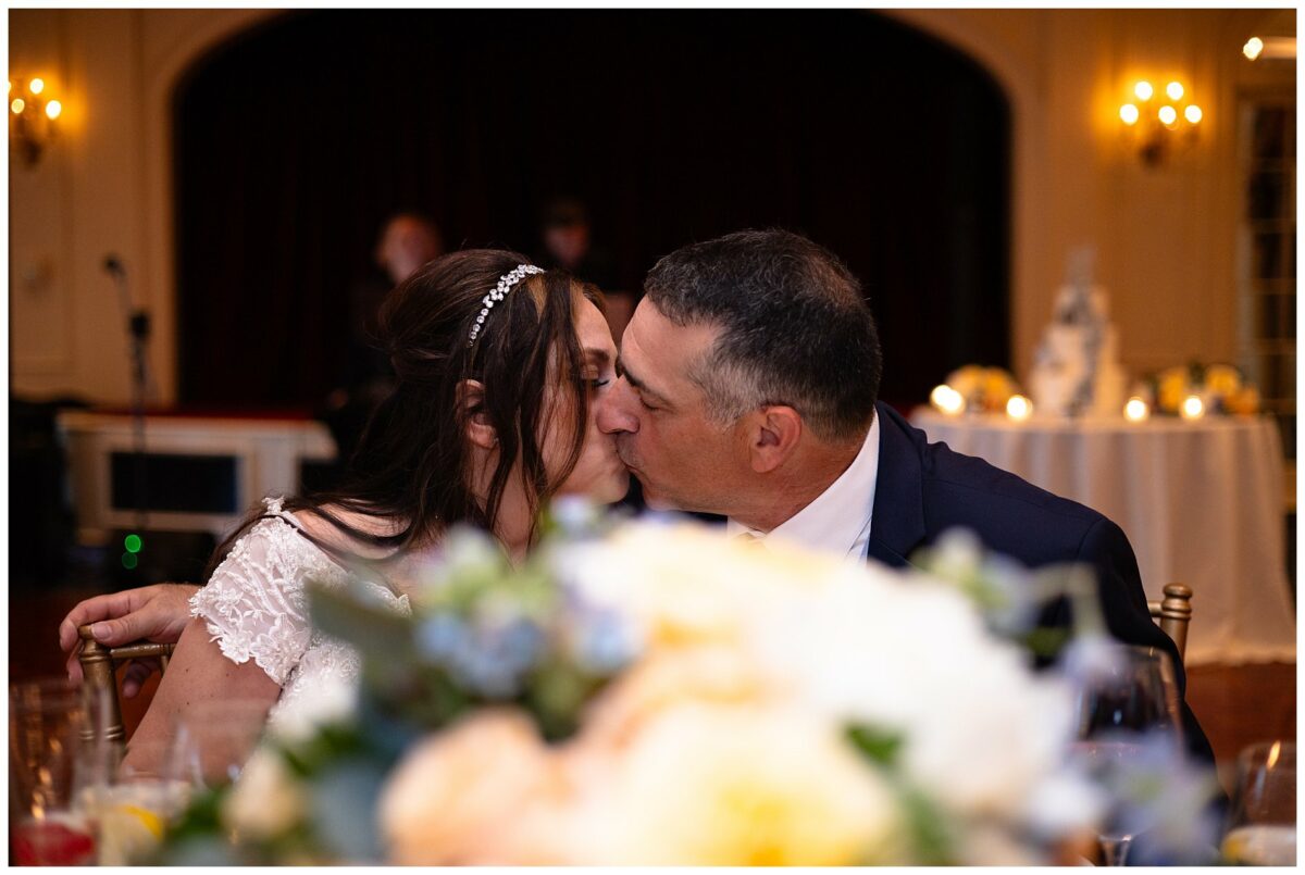 wedding couple kisses at table