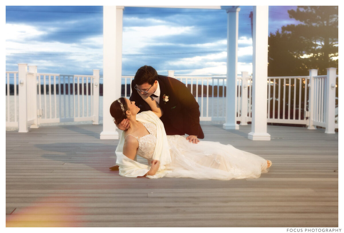 wedding couple on deck of spruce point inn