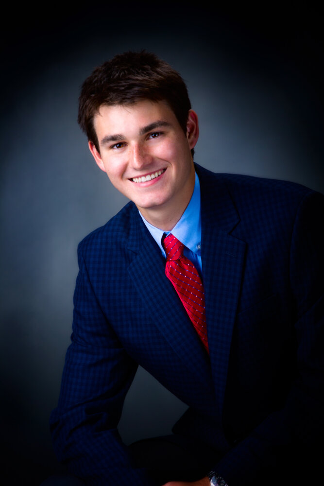 greely high school boy from cumberland maine photographed in suit jacket and tie for senior pictures in studio