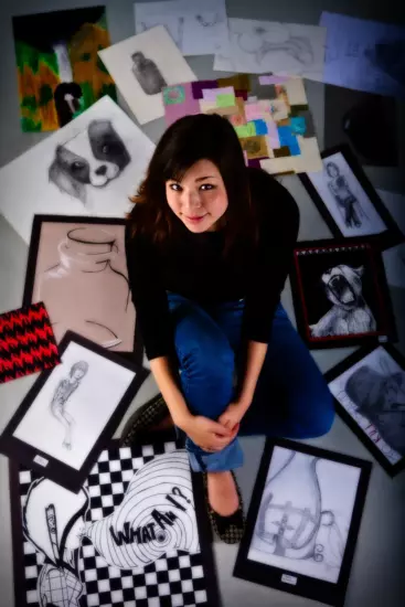 High school senior pictures of art student with drawings in portland maine photography studio