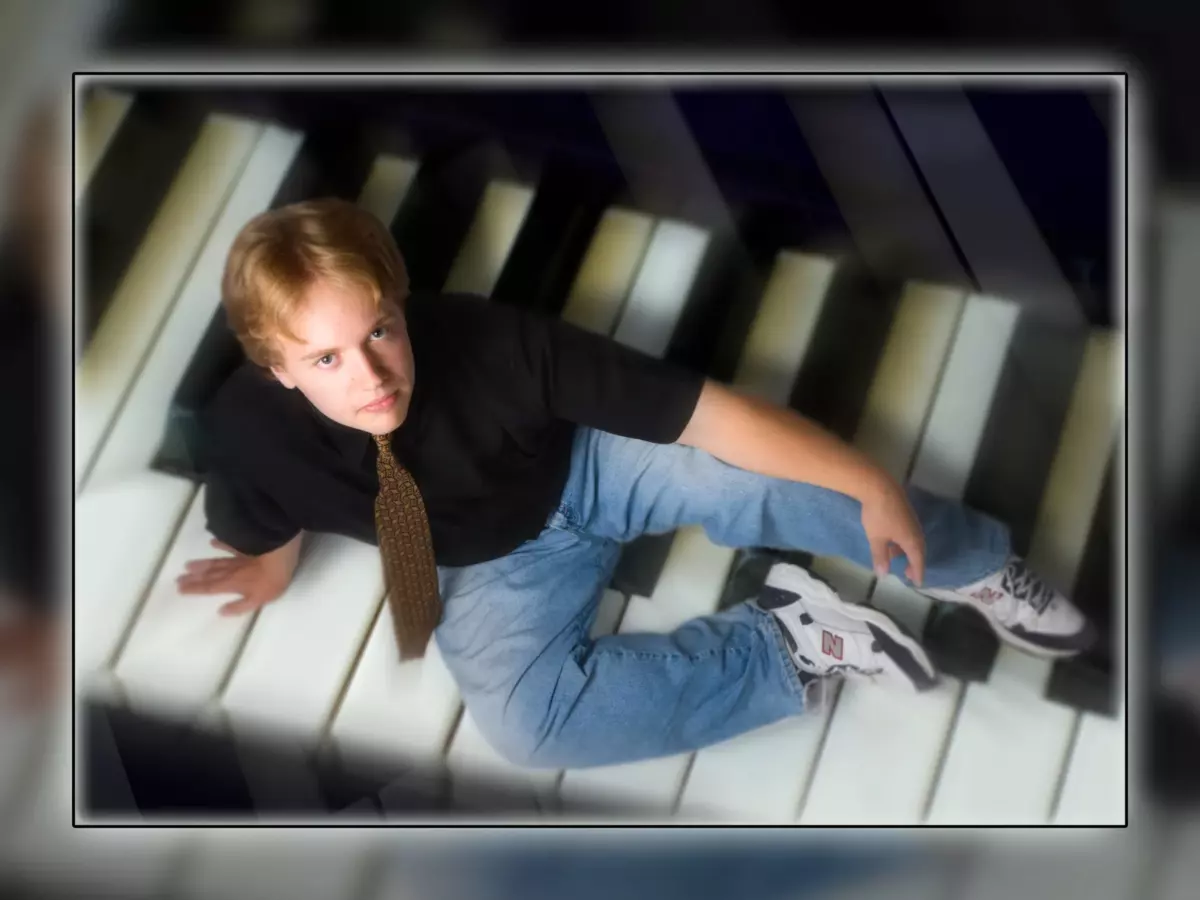 artistic senior photo of musician on keyboard in maine photography studio