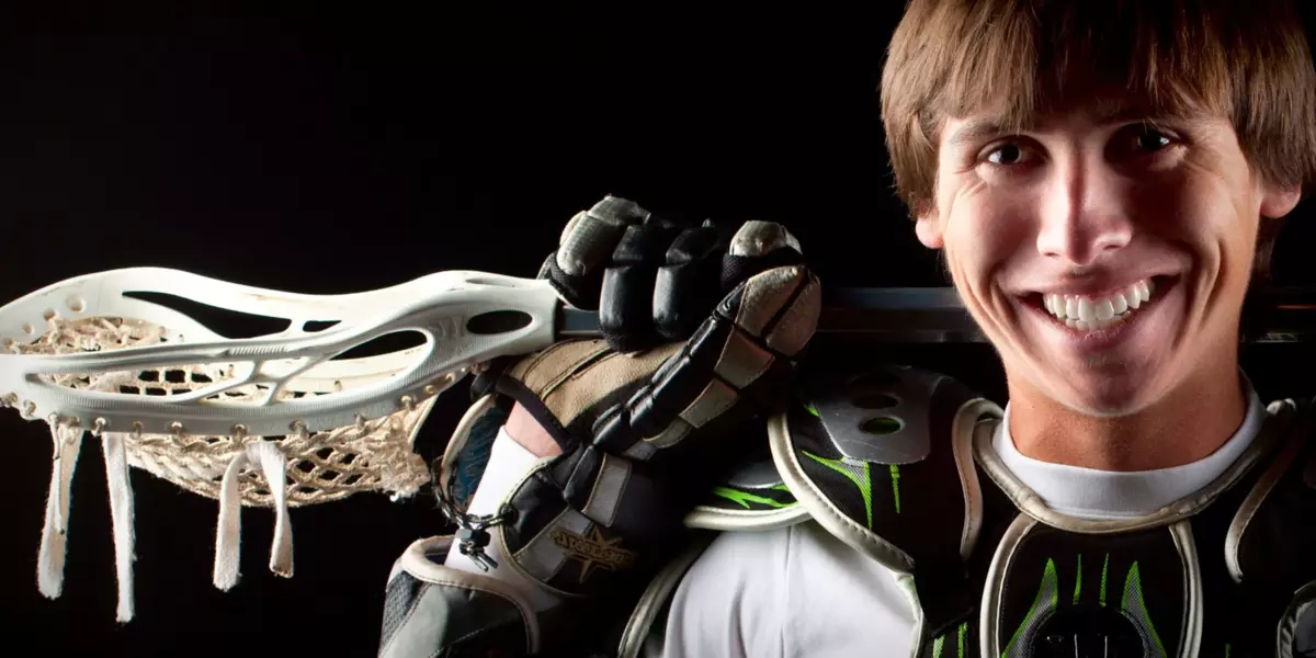 boy with lacrosse stick at maine photography studio  for senior pictures