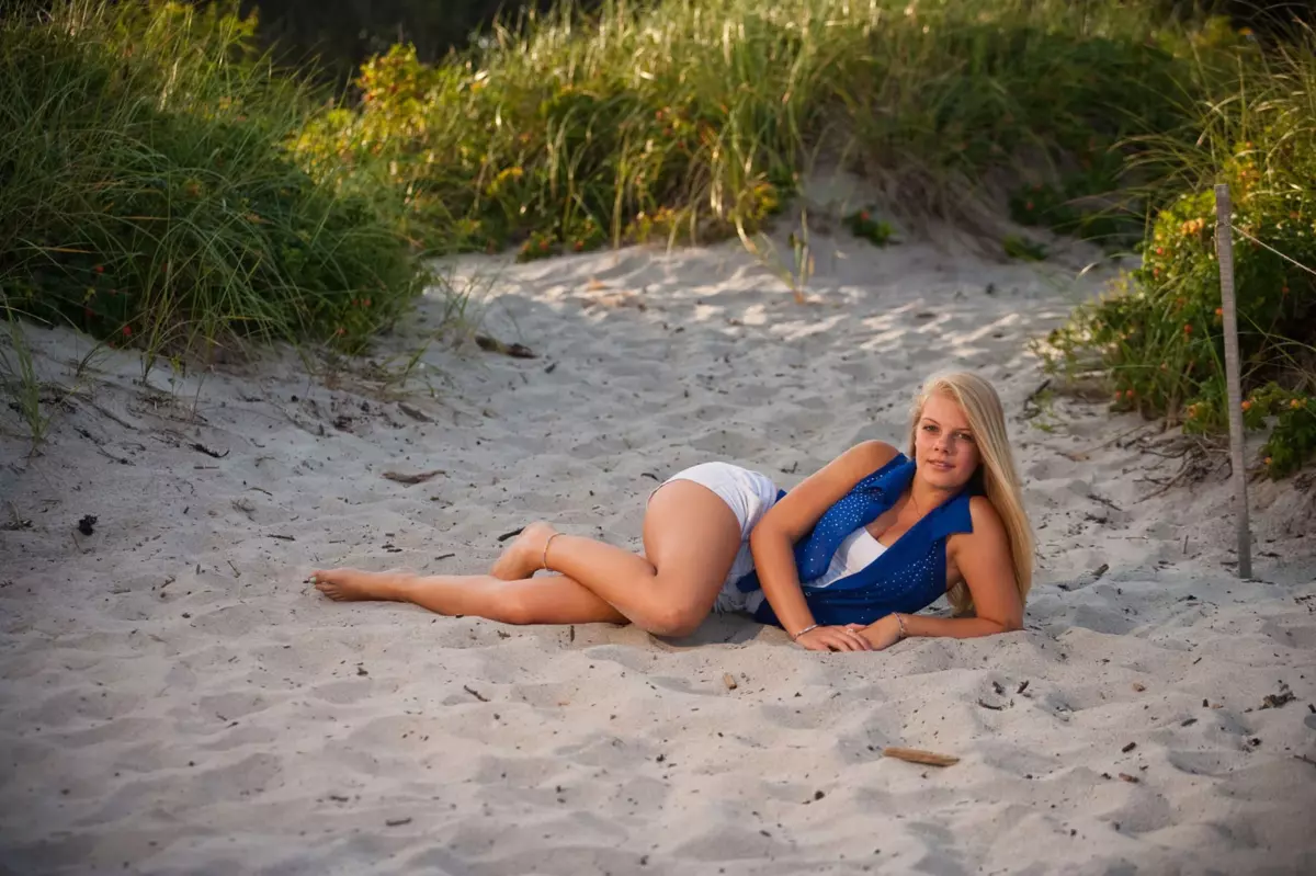 brunswick high school girl on sand during professional senior photos in maine at the beach