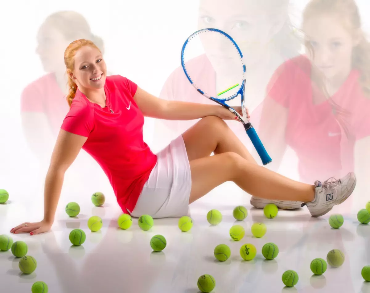 cumberland maine girl photographed with tennis equipment and outfit for athletic senior pictures in studio