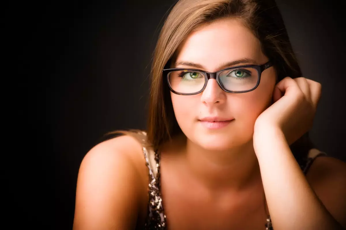 girl with glasses photographed in professional photograph studio for senior pictures in maine